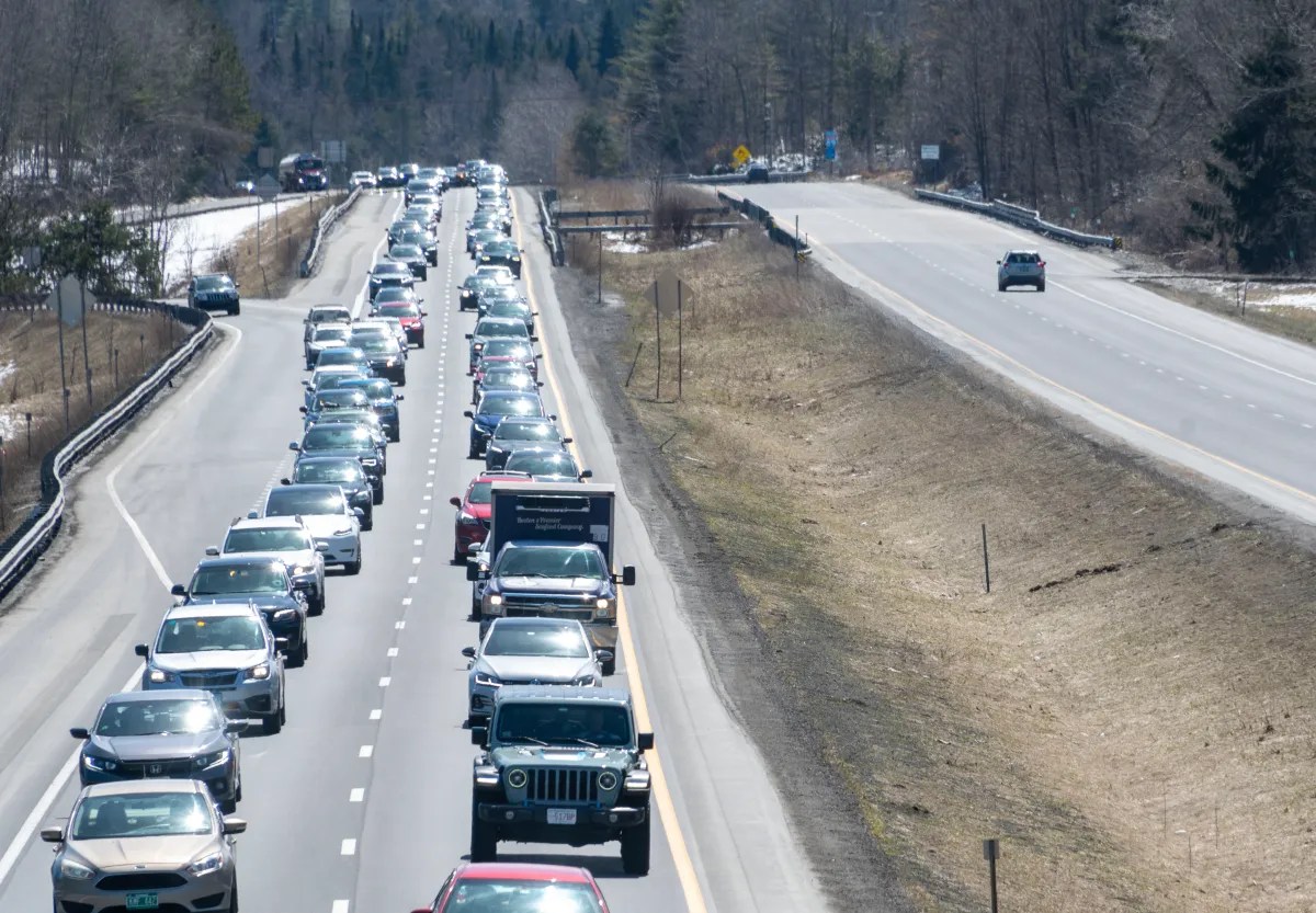 Traffic congestion on one side of a highway with clear lanes on the opposite side.