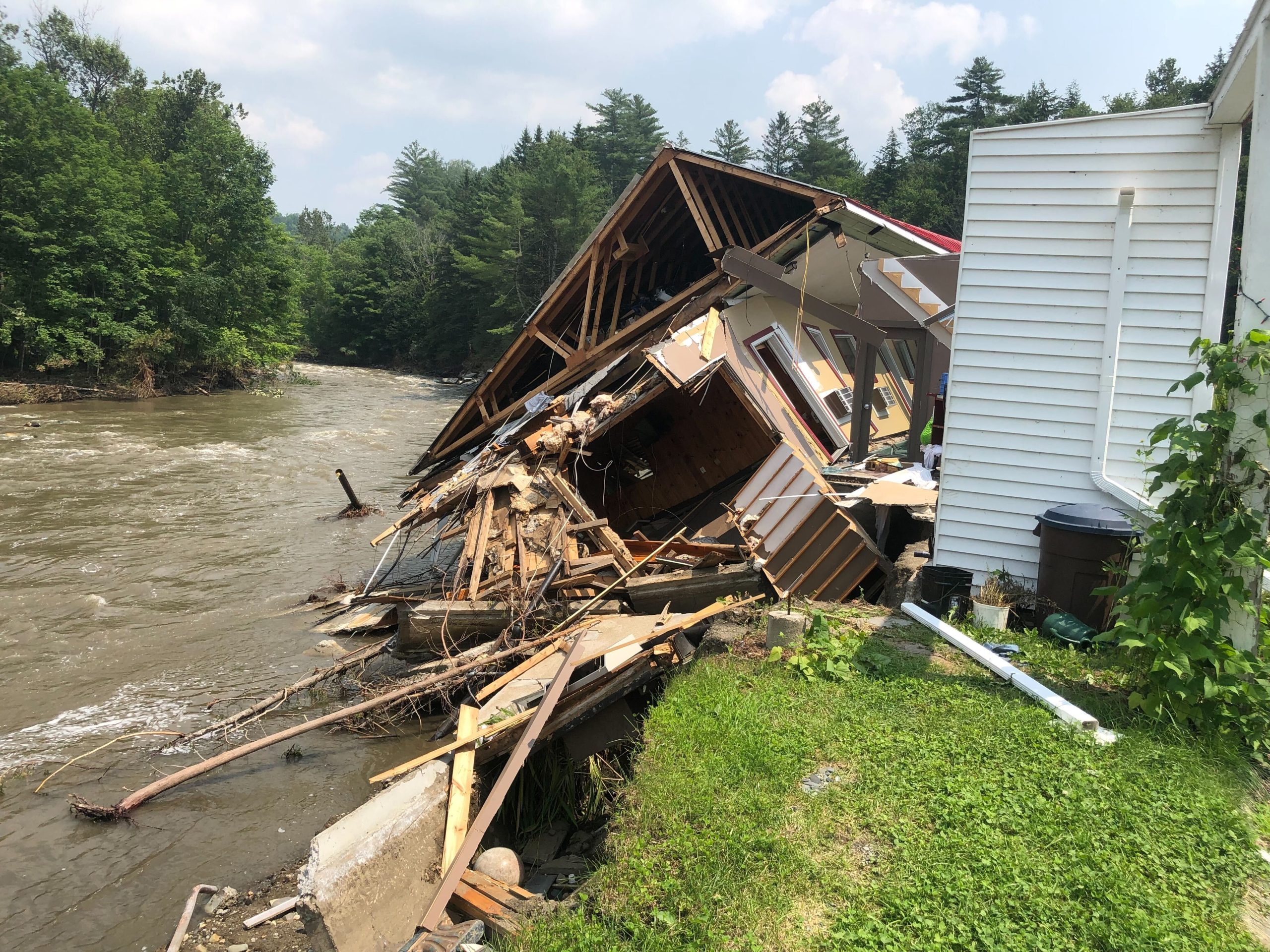 a house that has been ripped apart by a river.