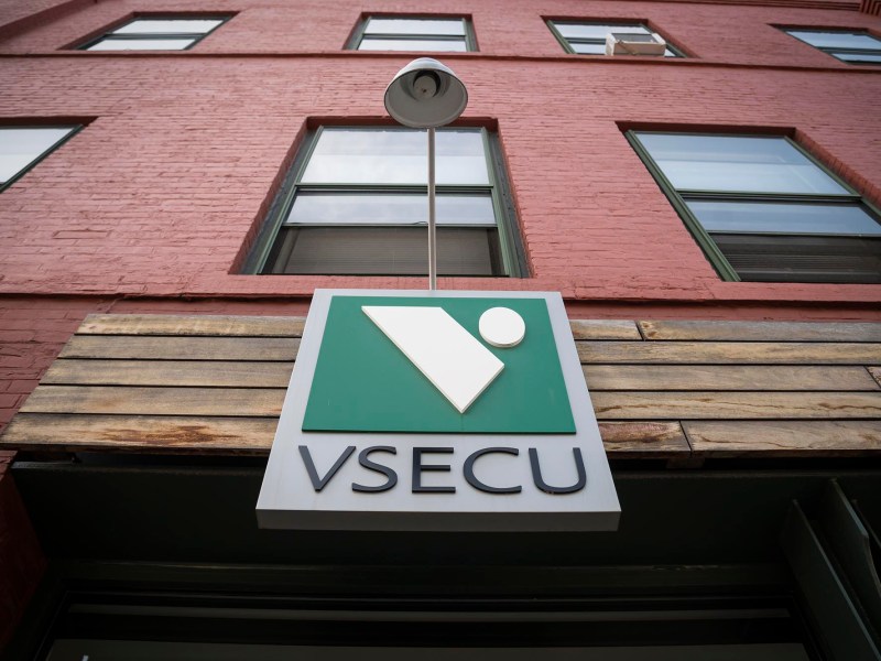 A sign that says vsecu on the side of a building.