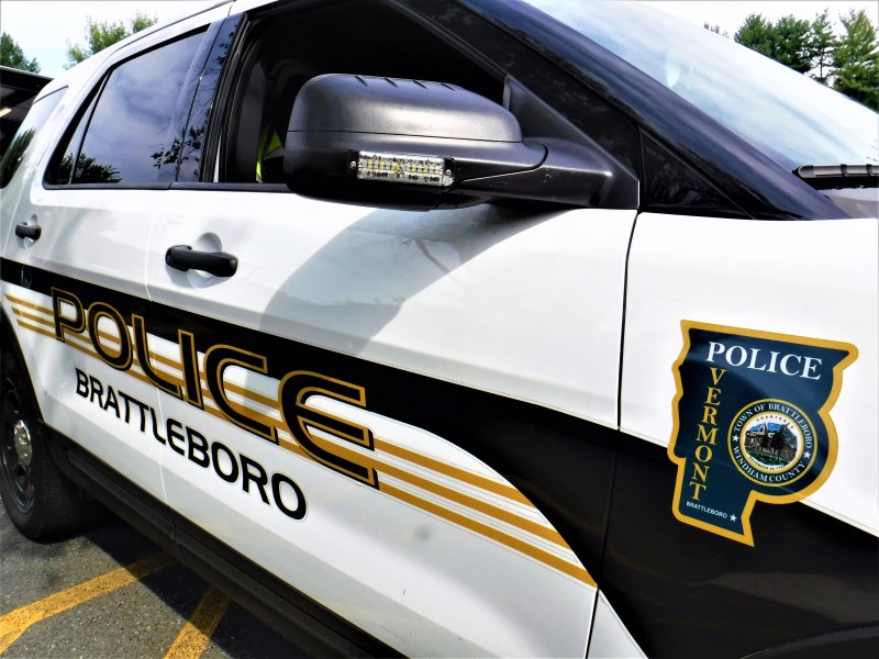 A Brattleboro Police Department patrol car parked outdoors, featuring the department's badge and logo on the door.